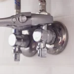 plumber-turns-nut-on-angle-valve-under-wash-basin-2023-11-27-04-52-09-utc-scaled.jpg