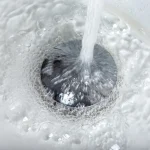 tap-water-flowing-into-stainless-steel-drain-2023-11-27-05-26-18-utc-scaled.jpg